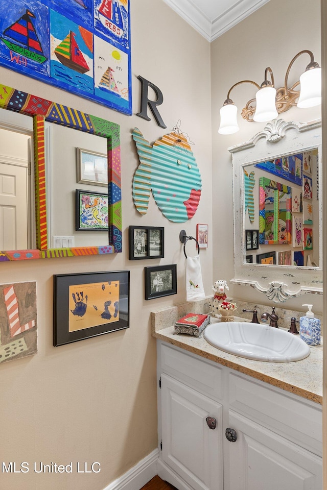 bathroom with crown molding and vanity