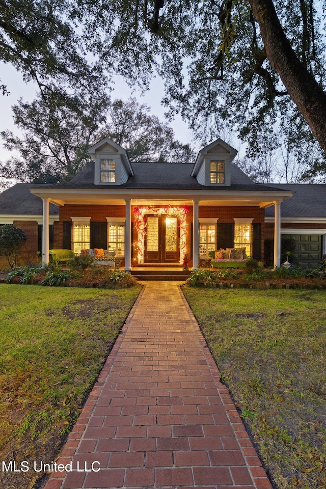 view of front of house with covered porch and a front yard