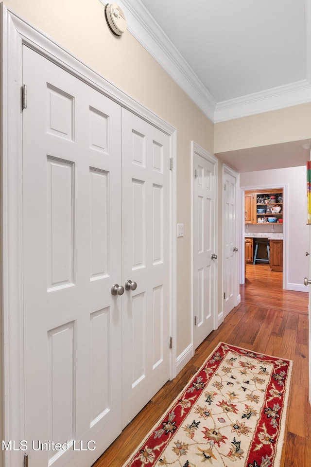 hall with crown molding and hardwood / wood-style flooring