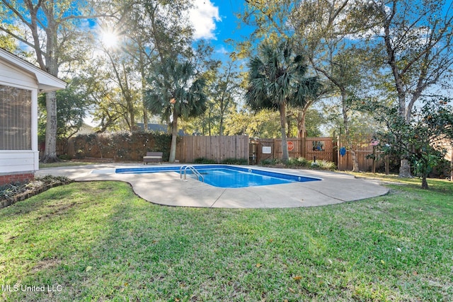 view of swimming pool with a lawn and a patio area