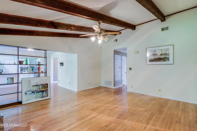 419 Cove Dr, Biloxi, MS 39531 - unfurnished living room featuring a ceiling fan, lofted ceiling with beams, light wood-type flooring, and visible vents