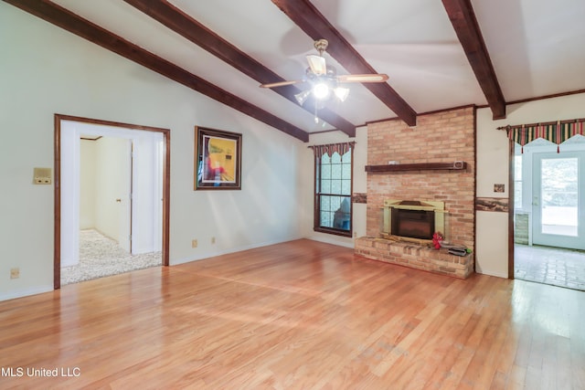 419 Cove Dr, Biloxi, MS 39531 - unfurnished living room featuring a ceiling fan, a wealth of natural light, light wood finished floors, and vaulted ceiling with beams