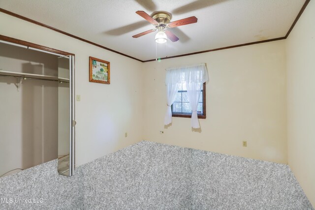 419 Cove Dr, Biloxi, MS 39531 - unfurnished bedroom featuring ceiling fan, ornamental molding, carpet, and a closet