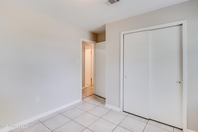 1302 Parktown Dr, Ocean Springs, MS 39564 - unfurnished bedroom featuring light tile patterned floors, baseboards, a closet, and visible vents
