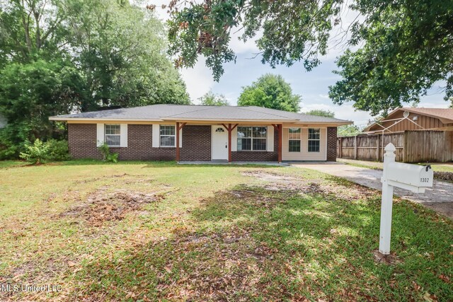1302 Parktown Dr, Ocean Springs, MS 39564 - ranch-style home with brick siding, fence, and a front lawn