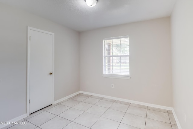 1302 Parktown Dr, Ocean Springs, MS 39564 - spare room with baseboards, a textured ceiling, and light tile patterned flooring