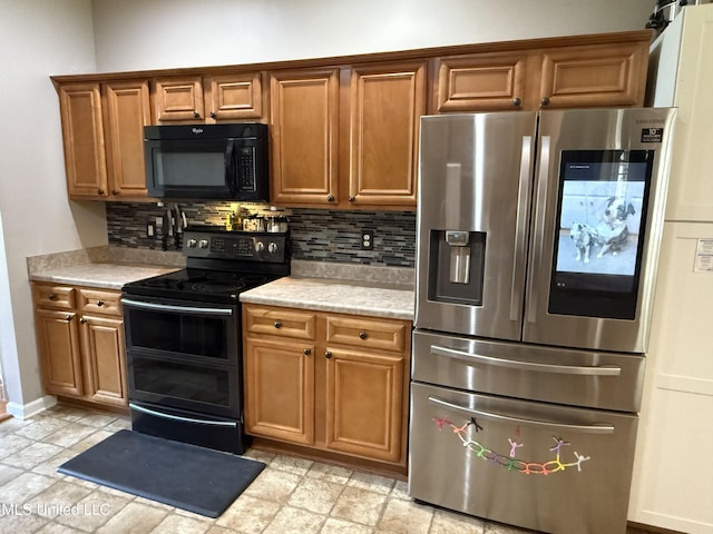 25 Dry Field Rd, Byhalia, MS 38611 - kitchen with black appliances, decorative backsplash, light countertops, and brown cabinetry