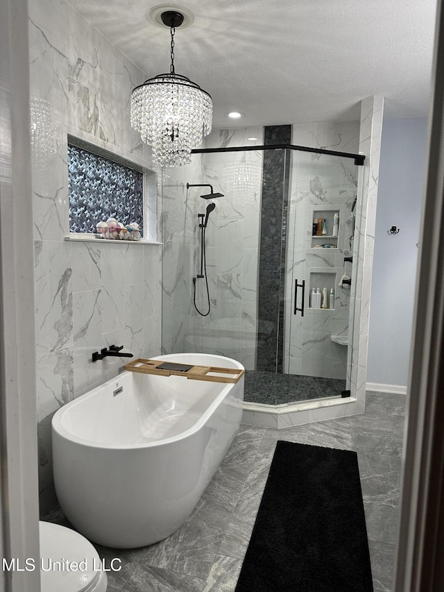 25 Dry Field Rd, Byhalia, MS 38611 - full bath featuring a soaking tub, a marble finish shower, marble tiled floors, a chandelier, and a textured ceiling