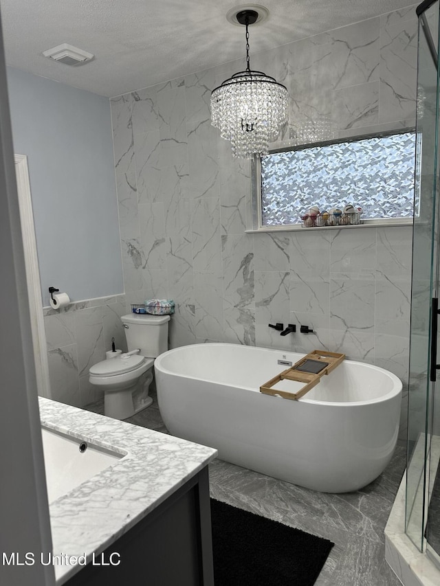 25 Dry Field Rd, Byhalia, MS 38611 - full bath with tile walls, vanity, a textured ceiling, a soaking tub, and a chandelier
