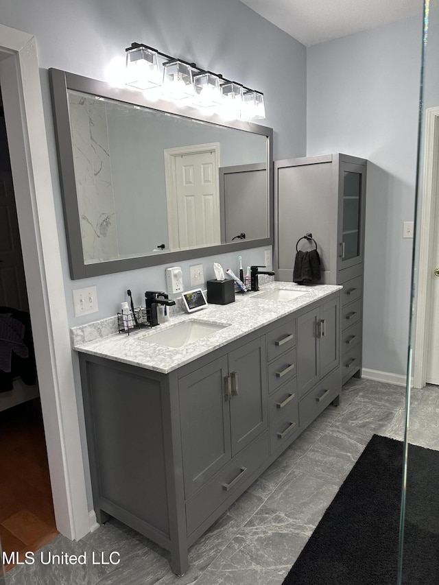 25 Dry Field Rd, Byhalia, MS 38611 - bathroom featuring double vanity and marble look tiles