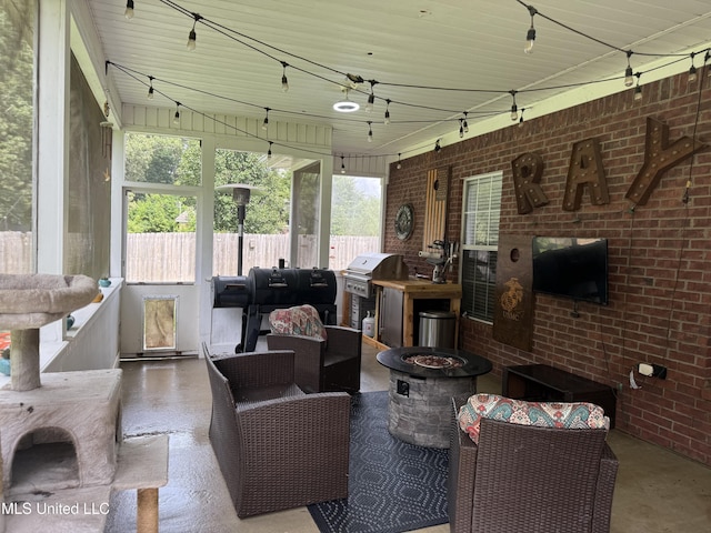 25 Dry Field Rd, Byhalia, MS 38611 - living room with rail lighting, brick wall, and concrete flooring