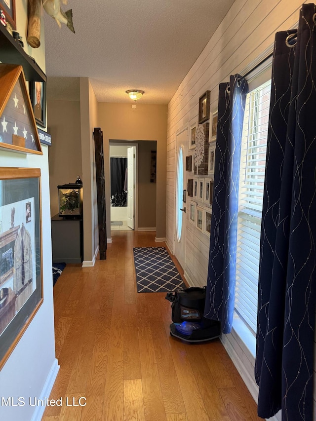 25 Dry Field Rd, Byhalia, MS 38611 - corridor with wood finished floors, a textured ceiling, and wooden walls