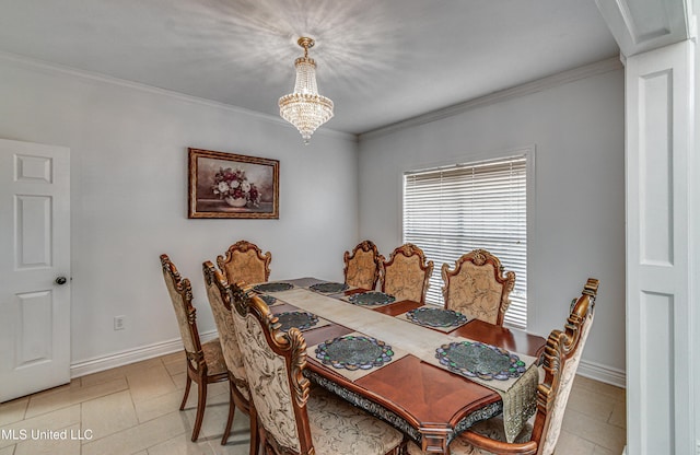 dining space featuring ornamental molding, baseboards, and an inviting chandelier