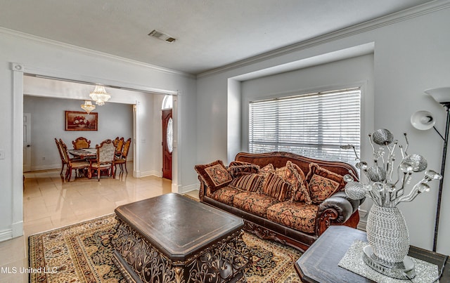 living room with ornamental molding, visible vents, and baseboards