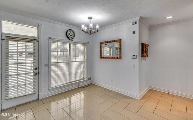 unfurnished dining area with crown molding, a notable chandelier, light tile patterned floors, a textured ceiling, and baseboards