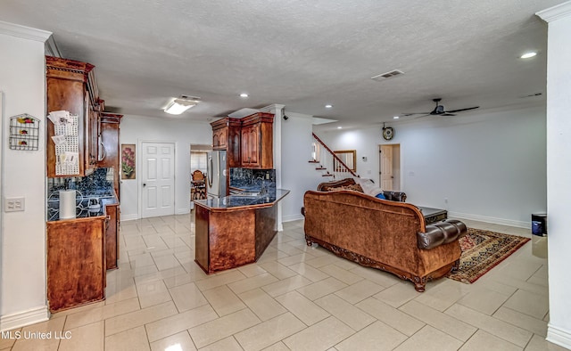 living area featuring visible vents, a ceiling fan, stairs, a textured ceiling, and recessed lighting