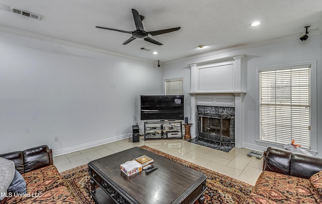 living room featuring a high end fireplace, tile patterned flooring, visible vents, and crown molding