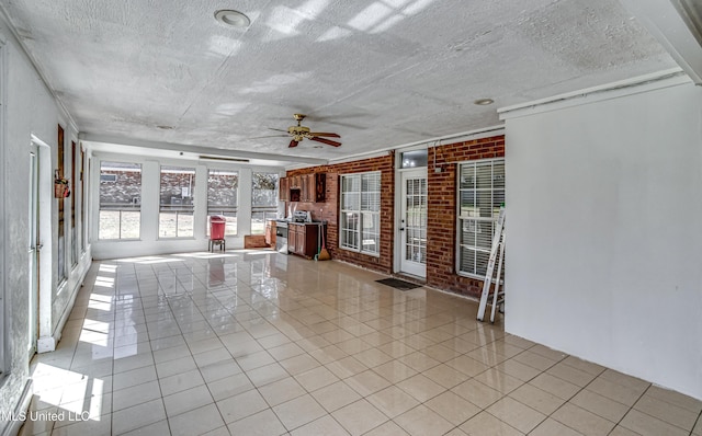 unfurnished sunroom with a ceiling fan