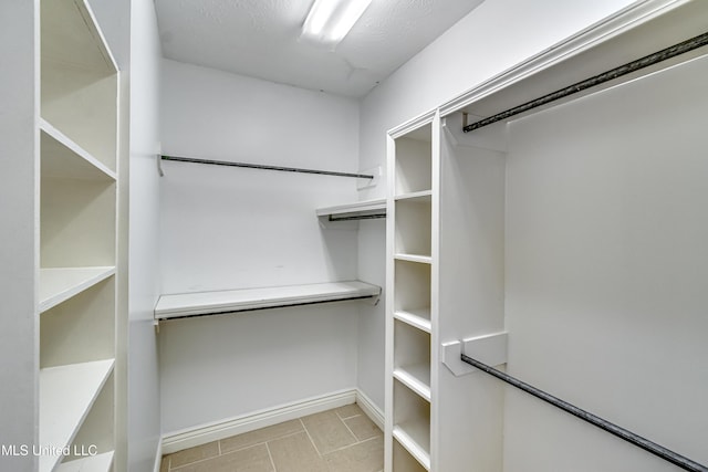 spacious closet featuring tile patterned flooring