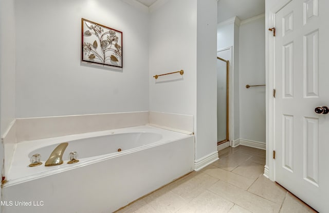 bathroom featuring baseboards, tile patterned flooring, a garden tub, and a shower stall