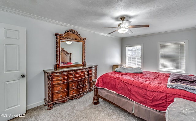 bedroom with crown molding, a ceiling fan, carpet flooring, a textured ceiling, and baseboards