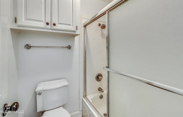 full bathroom with bath / shower combo with glass door and toilet