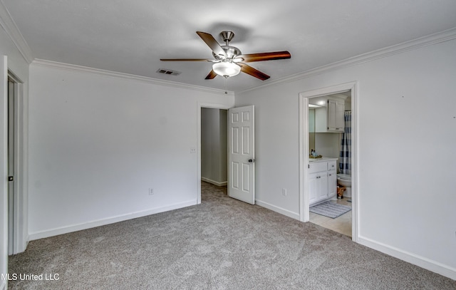 unfurnished bedroom with baseboards, visible vents, light colored carpet, ornamental molding, and ensuite bathroom