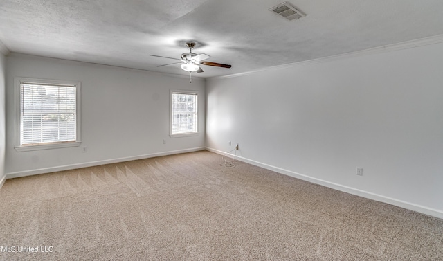 unfurnished room featuring light carpet, baseboards, visible vents, a ceiling fan, and a textured ceiling