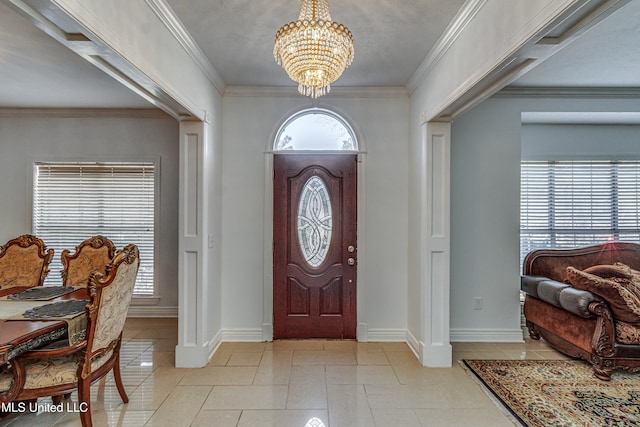 entryway with a chandelier, light tile patterned flooring, baseboards, and crown molding