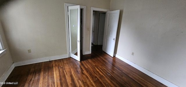 1080 Alta Vista Blvd, Jackson, MS 39209 - unfurnished bedroom featuring dark wood finished floors and baseboards