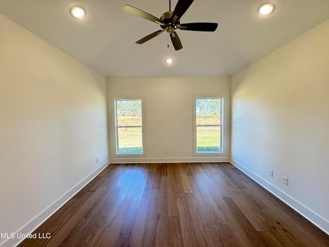 unfurnished room with dark hardwood / wood-style floors, a healthy amount of sunlight, and ceiling fan