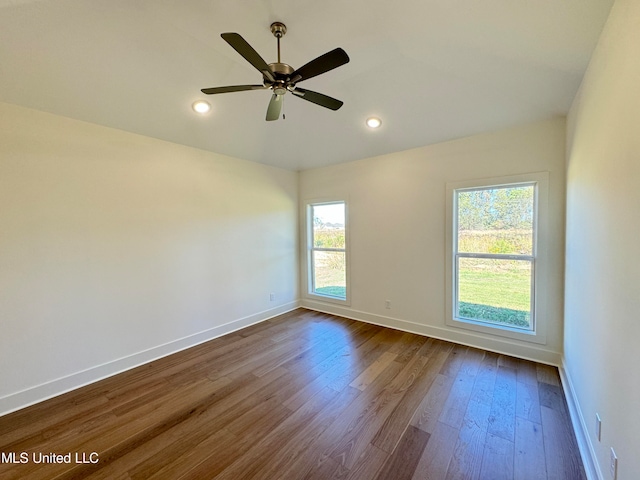 unfurnished room with ceiling fan and wood-type flooring