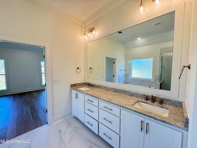 bathroom with vanity, crown molding, a shower with shower door, and hardwood / wood-style flooring