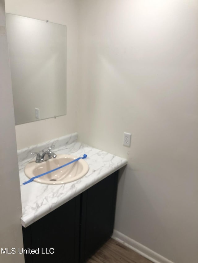 bathroom featuring hardwood / wood-style flooring and vanity