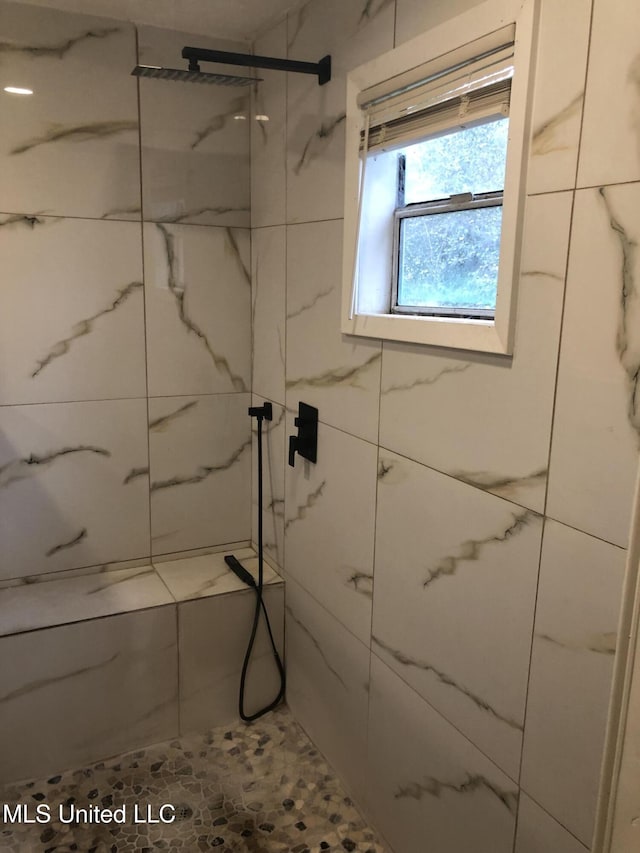 bathroom with a tile shower