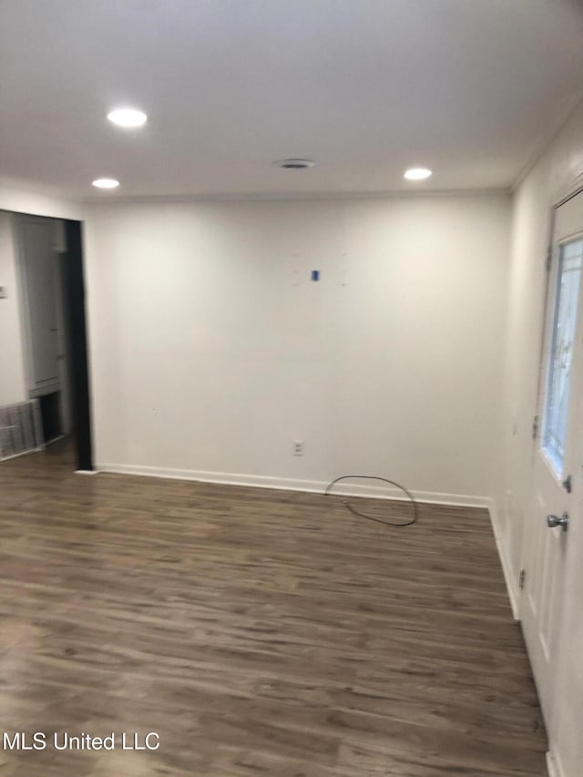 spare room featuring dark hardwood / wood-style flooring