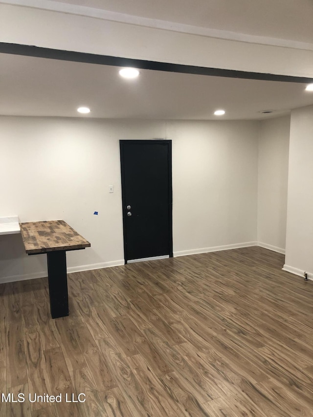 basement with dark wood-type flooring