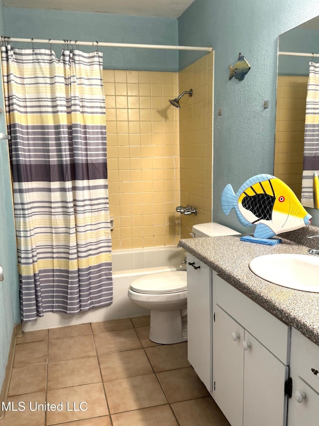 3310 Washington Ave Unit 1315, Pascagoula, MS 39581 - bathroom featuring vanity, toilet, shower / bath combo with shower curtain, a textured wall, and tile patterned flooring