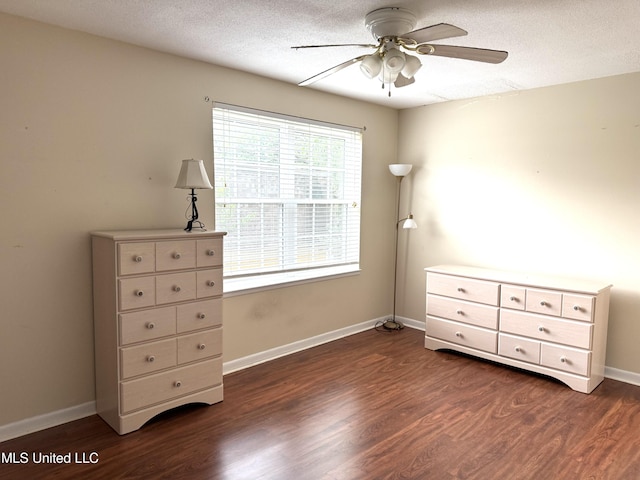 3310 Washington Ave Unit 1315, Pascagoula, MS 39581 - unfurnished bedroom with dark wood-type flooring, baseboards, a textured ceiling, and ceiling fan