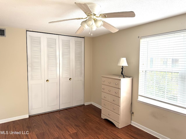 3310 Washington Ave Unit 1315, Pascagoula, MS 39581 - bedroom featuring dark wood-type flooring, a closet, baseboards, and a ceiling fan
