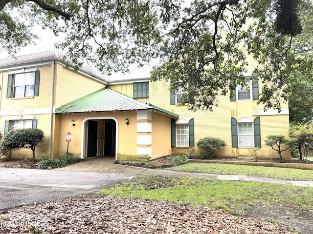 3310 Washington Ave Unit 1315, Pascagoula, MS 39581 - view of front of home with driveway, brick siding, and metal roof