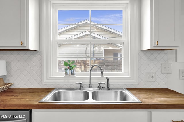 kitchen with white cabinetry, sink, a healthy amount of sunlight, and dishwasher