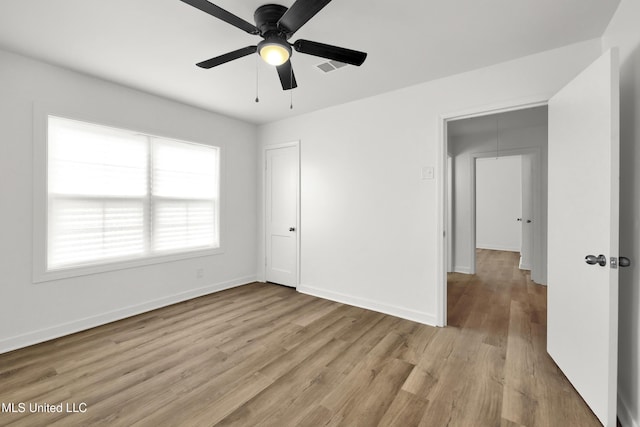 unfurnished bedroom with light wood-type flooring and ceiling fan