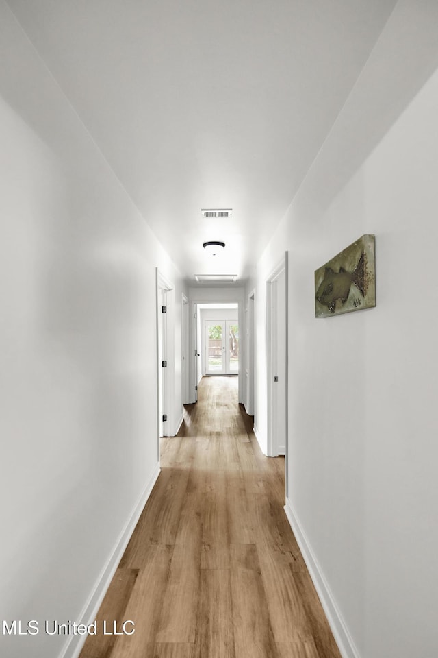 hall with light wood-type flooring