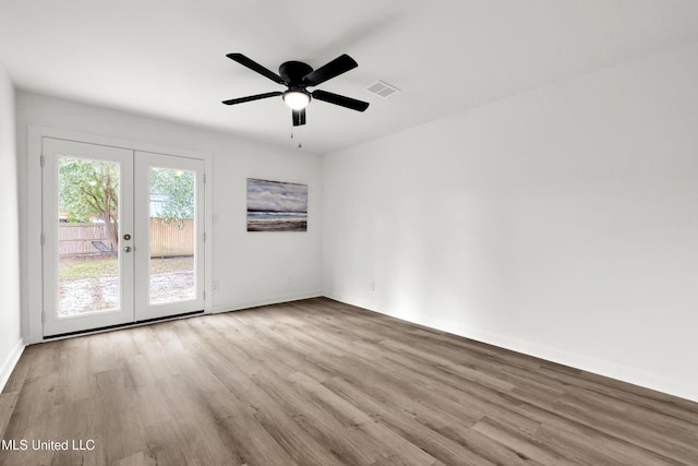 spare room featuring light wood-type flooring, french doors, and ceiling fan