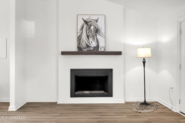 unfurnished living room featuring hardwood / wood-style floors