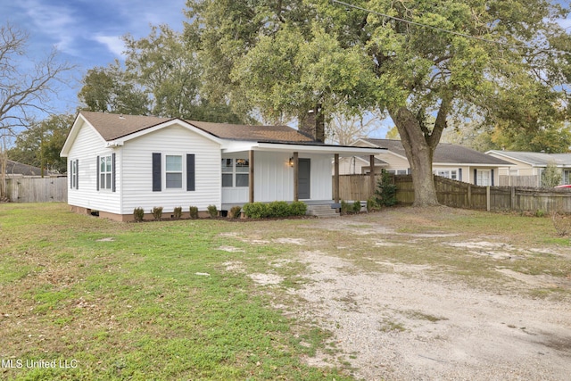 ranch-style home with covered porch and a front lawn