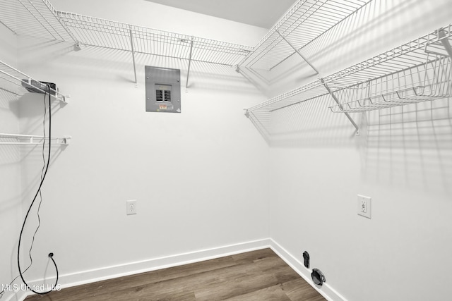 clothes washing area with wood-type flooring and electric panel