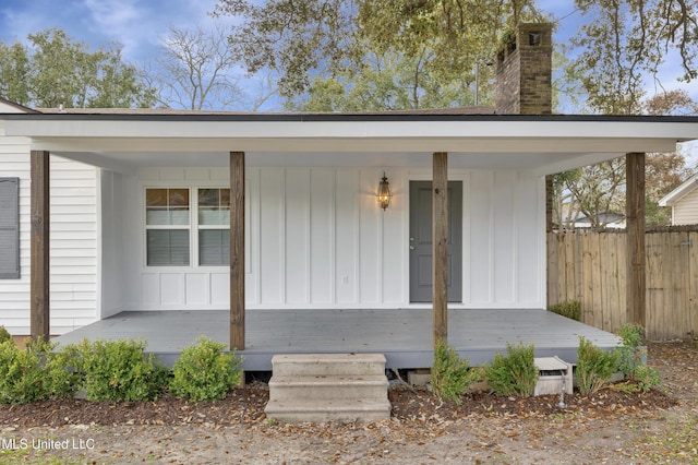 view of exterior entry with covered porch