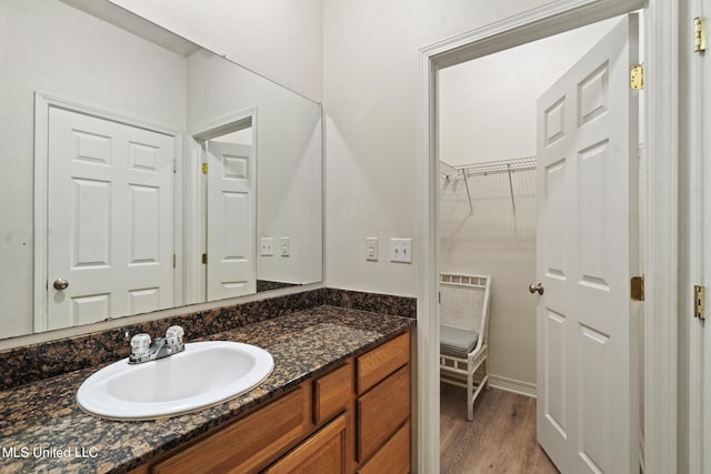 bathroom featuring vanity and wood-type flooring